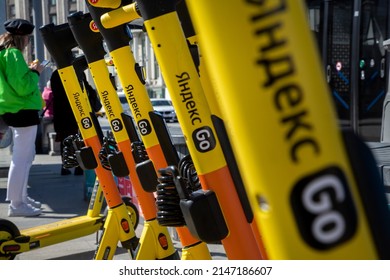 Moscow, Russia. 14th April, 2022. Closeup view of Yandex Go yellow electric scooters which are ready for rent on sidewalk in central Moscow, Russia
