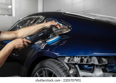 Moscow, Russia 20 September 2022: A Man Polishes A Blue Porsche 911 Sports Car