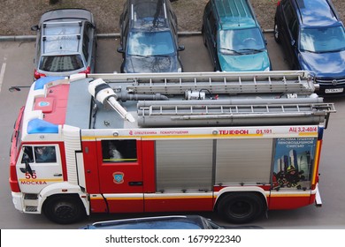 Moscow, Russia - 22 March 2020: Special Rescue Fire Truck, Top View. Protection, Rescue From Danger. Fire Fighter In Protective Helmet.