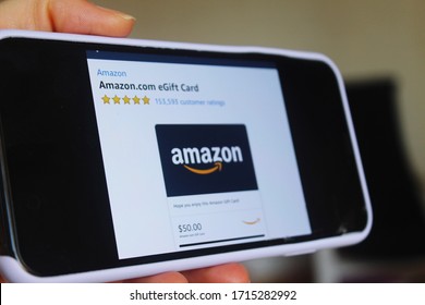 Moscow, Russia - 25 April 2020: Mobile phone screen with information on purchase of Amazon eGift Card. The card can be used to make purchases on the Amazon website, a company founded by Jeff Bezos.