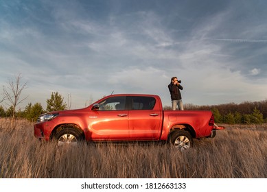 Moscow / Russia - 29.10.2019: orange pick-up toyota hilux on the autumn field