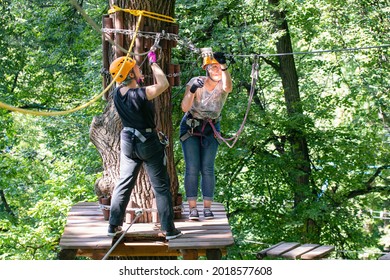 Moscow, Russia - 9th August, 2020: Physical Activities In The City. Two Young Women In Forest Aerial Adventure Park (rope Park).