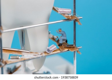 Moscow, Russia - 9th Matra 2021: A Model Of A Human Tooth And An Art Installation Of Small Figures Around It. Tooth Reconstruction, Dental Concept.