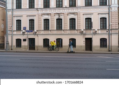 Moscow, Russia - April 11, 2020: Spring City. Photography Of Delivery Man At The Street Sretenka Within Day. Bike Usage/ Using. Side View. Concepts - Stay Home. Coronavirus Pandemic Lifestyle