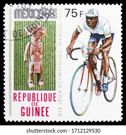 MOSCOW, RUSSIA - APRIL 18, 2020: Postage Stamp Printed In Guinea Shows Cycling, Summer Olympics 1968, Mexico Serie, Circa 1969