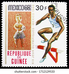 MOSCOW, RUSSIA - APRIL 18, 2020: Postage Stamp Printed In Guinea Shows Hurdles, Summer Olympics 1968, Mexico Serie, Circa 1969