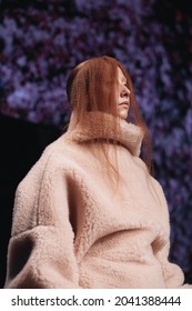 MOSCOW RUSSIA - April 20 2021: Redhead Woman Wearing The Beige Winter Warm Fur Sweater. Vertical Fashion Shot From Catwalk