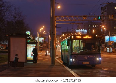 Moscow, Russia - April 25, 2020: Moscow Cityscape In Night. Illuminated Street. Almost No People. Blue Bus Stop. Coronavirus Pandemic Lifestyles. Concepts - Stay Home, Save Life. 