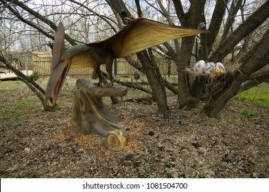 MOSCOW, RUSSIA - APRIL 29, 2017: Pterodactyl Near The Nest With Eggs, Prehistoric Animal In Dinosaur Park, Moscow, Russia