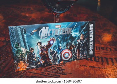 Moscow, Russia - April 8, 2019: An invitation to "The Avengers" movie, Marvel & The Walt Disney Company comic book movie, on warm dark background, sign says "The Avengers, invitation"