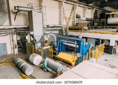 Moscow, Russia - August 10, 2021: Woman Working On Paper Cutting Machine In Paper Mill. Paper Mill.