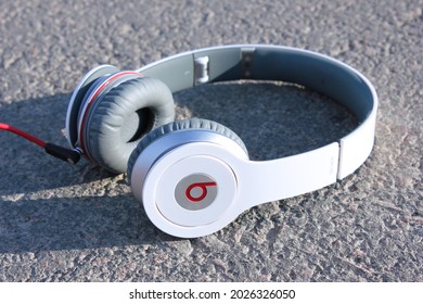 Moscow, Russia - August 16, 2021: Headphones Beats by Dr. Dre Solo HD in a red box. Beats by Dre produces audio products. Illustrative editorial image; on grunge grey background