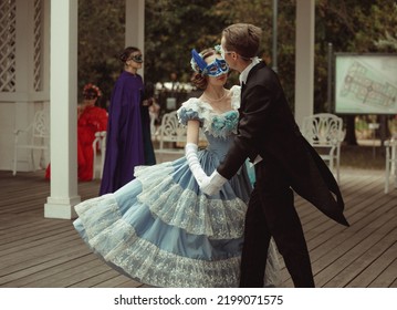 Moscow, Russia - August 19, 2022: Beautiful People Whirling In The Dance At Masquerade Ball In Historical Costumes And Masks.