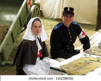 Moscow, Russia - August 2018: Army Doctor And Nurse Of The Russian Empire Of 19th Century During The Moscow Historical Festival Times And Epochs. Reconstruction Of The Military Field Hospital