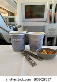 Moscow, Russia - August, 2020: Tomato juice and cappuccino on board an Aeroflot aircraft in business class