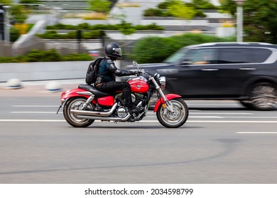 Moscow, Russia - August 2021: Biker On Red Kawasaki Vulcan 1600 Mean Streak Moving On The Street On High Speed.