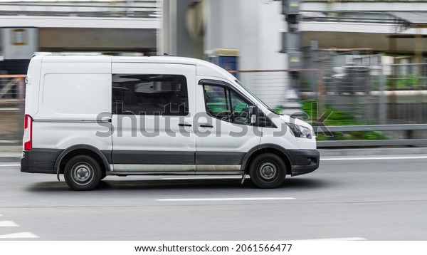 Moscow, Russia - August 2021: Ford Transit Fourth\
generation in the city street. Side view of white light commercial\
vehicle