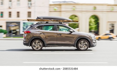 Moscow, Russia - August 2021: Hyundai Tucson 2018 Facelift Car Rides Through The City On High Speed. Side View Of Fast Moving Brown Suv Car On Moscow Streets