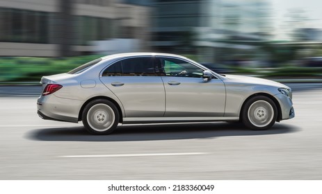 Moscow, Russia - August 2021: Mercedes E Class On The Road In Motion. Fast Speed Drive On City Road. Side View Of Moving Silver Car On The Street