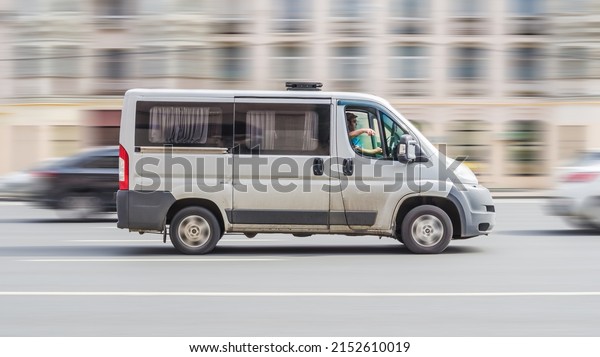 Moscow,\
Russia - August 2021: Ram ProMaster 1500 window or glazed van at\
the city street, side view. Third generation vehicle of light\
commercial van Peugeot Boxer or Citroen\
Relay