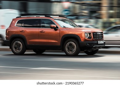 Moscow, Russia - August 2022: Haval Dargo Test Drive On Moscow Streets. Haval Big Dog Crossover Driving In City. Fast Moving Orange SUV On Urban Road, Side View