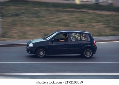 Moscow, Russia - August 2022: Old Car Renault Clio II In Motion. Young Driver Is Distracted By His Phone While Driving A Car