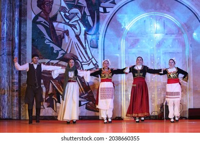 MOSCOW, RUSSIA – AUGUST 21, 2021: Open festival "Russia-Greece. Together Through the Ages". Greek dancing. Traditional national dance of Greece. Event with artists dancing sirtaki in folk costumes