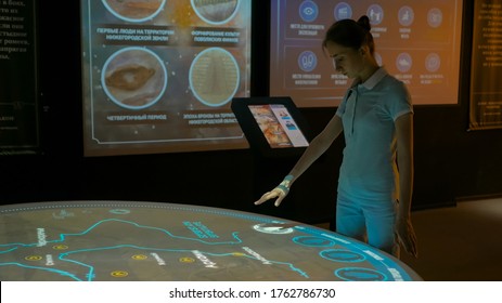 MOSCOW, RUSSIA - August 29, 2018: Modern Museum Of Russia History. Woman Using Interactive Display With No Touch Control Technology. Education And Modern Concept