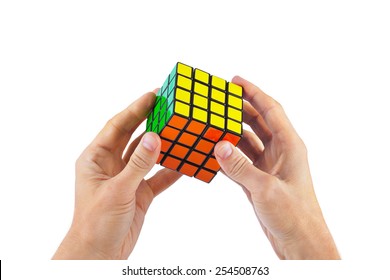 MOSCOW, RUSSIA - August 31, 2014: Hands and Rubik's cube puzzle isolated on the white background. Cube was invented by a Hungarian architect Erno Rubik in 1974.