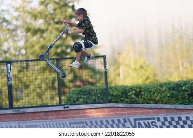 Moscow, Russia - August 5, 2022: Push Scooter Stunt On The Urban Sport Ground In Summer Day. Boy Showing  Trick. Jumping. Healthy Lifestyle. Extreme Sports Is Popular Among Youth. Panoramic Image