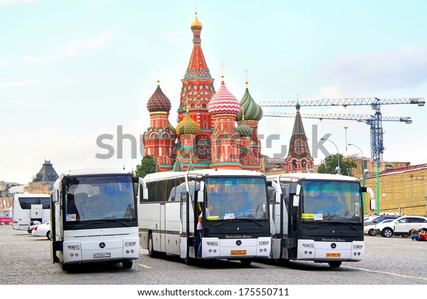 MOSCOW, RUSSIA - AUGUST 7, 2012: White\
Mercedes-Benz O350RHD Tourismo interurban coaches at the Red Square\
near Saint Basil\'s\
Cathedral.