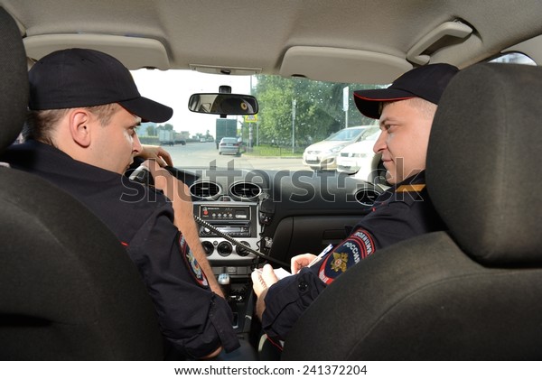 MOSCOW, RUSSIA - AUGUST 8, 2013:  Police in the\
patrol car. Patrol and inspection service of the police provides\
public safety in the\
capital.