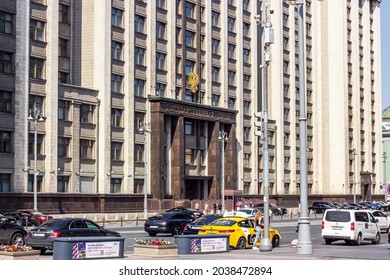 MOSCOW, RUSSIA - AUGUST 9, 2021: The State Duma government building facade with golden eagle symbol and the street view