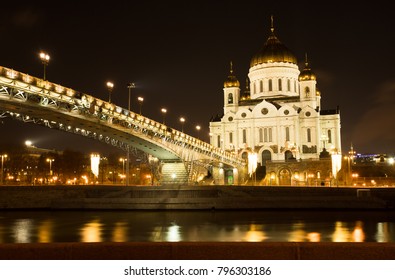 Moscow, Russia. Cathedral Of Christ Savior With Bridge With Illumination By Lamps At Winter Night. Famous Christian Landmark In Russia.