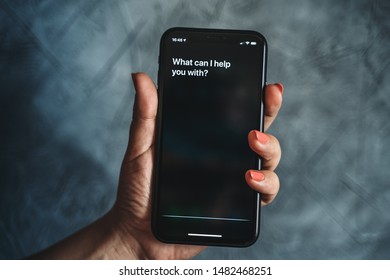 Moscow, Russia - Circa August 2019 : Siri - Apple Voice Assistant Activated By Voice In Female Hand And Text On Iphone Screen: What Can I Help You With? Voice Mode Of Interaction With Smartphone