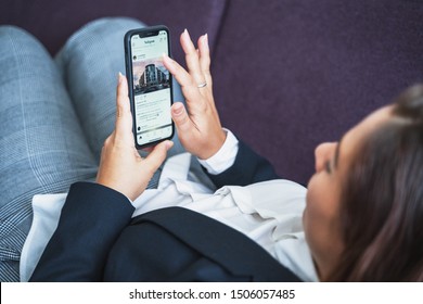 Moscow, Russia - Circa August 2019 : Young Woman Using Iphone And App Instagram, Scrolling Feed On Touchscreen With Finger, Social Media