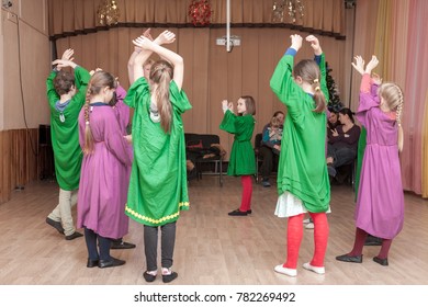 MOSCOW, RUSSIA - CIRCA DECEMBER, 2017: Open lesson of eurythmy. Waldorf school students of second class perform game exercise with teacher. Parents and guests in the background are watching.