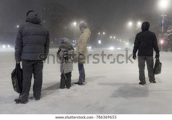 MOSCOW, RUSSIA - CIRCA JANUARY\
2016: People stand at a crossroads in winter during a heavy\
snowfall