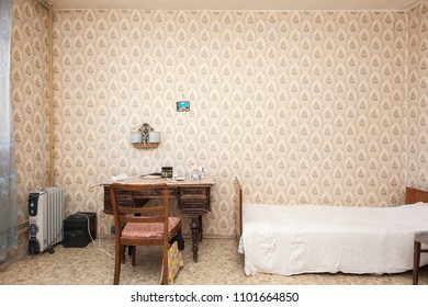 MOSCOW, RUSSIA - CIRCA MAY, 2018: A Room In A Two-room Apartment. Wallpapers. Linoleum Floor. Interior Items, Table, Chair, Bed.