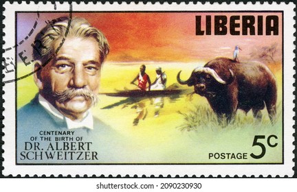 MOSCOW, RUSSIA - DECEMBER 03, 2021: A Stamp Printed In Liberia Shows Water Buffalo Egret, Man And Woman Paddling Canoe, Series Dr. Albert Schweitzer (1875-1965), Medical Missionary, 100th Anniv., 1975