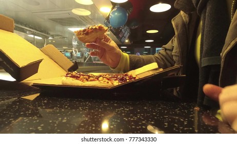 MOSCOW, RUSSIA - DECEMBER 17, 2018. Man Eating Freshly Baked Steaming Pizza At Domino's