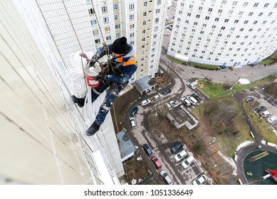 Moscow, Russia - December 18. 2018. Mountaineer Employee Of Public Services Warms Residential Building.