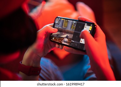 MOSCOW, RUSSIA - December 2019: Kid play PUBG: Mobile on iPhone 11 Pro smartphone close-up