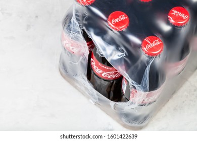 MOSCOW, RUSSIA - DECEMBER 25, 2019: Above View Of Package Of Coca-Cola Glass Bottles On Concrete Floor. Coca-Cola (Coke) Is Carbonated Soft Drink Manufactured By The Coca-Cola Company