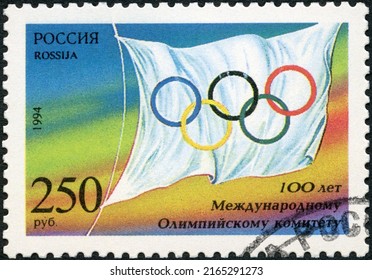 MOSCOW, RUSSIA - FEBRUARY 05, 2022: A Stamp Printed In Russia Shows Flag, The 100th Anniversary Of The International Olympic Committee, 1994