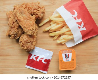 MOSCOW, RUSSIA - FEBRUARY 1, 2018: KFC (Kentucky Fried Chicken) Fast Food Meal with Chicken Nuggets, French Fries and Cheese Sauce. KFC is one of the Largest Fastfood Restaurant Chains in the World. 