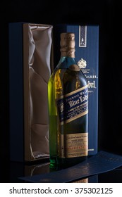 Moscow, Russia - February 10, 2016: a "Johnnie Walker Blue Label" luxury numbered whiskey with box and papers in a display window on black Background