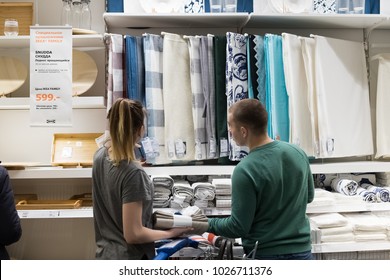 Moscow, Russia - February 10, 2018: Woman And Man Choose Liked Tablecloth For Dining Table In IKEA Close Up.