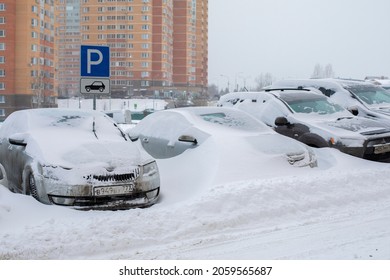 Moscow, Russia - February 13, 2021: Parking On The Street Covered With Snow. Car Drowned In Snow, Abnormal Amount Of Snowfall In Winter