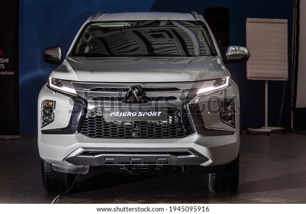 Moscow, Russia - February 17, 2021: All new Mitsubishi\
Pajero Sport. Montero. Car stand at the parking box, dark light.\

